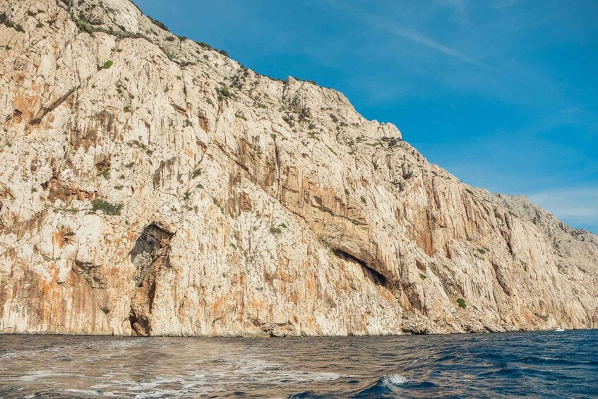 A rocky coastline with a large cave opening. 3
