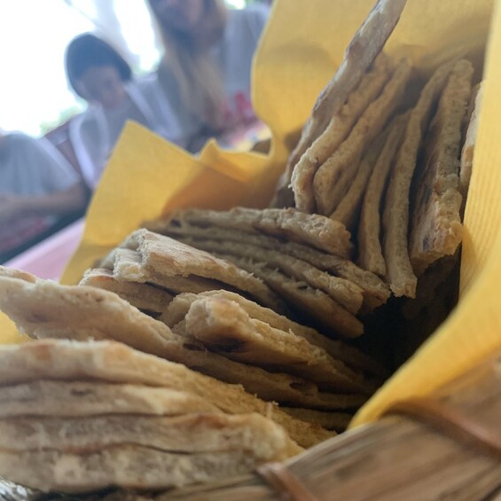 A stack of flatbreads in a yellow container. 5