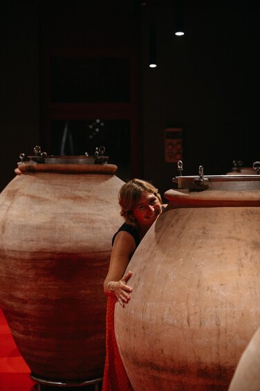 A person leaning on a large, cylindrical object with a red cloth. 4