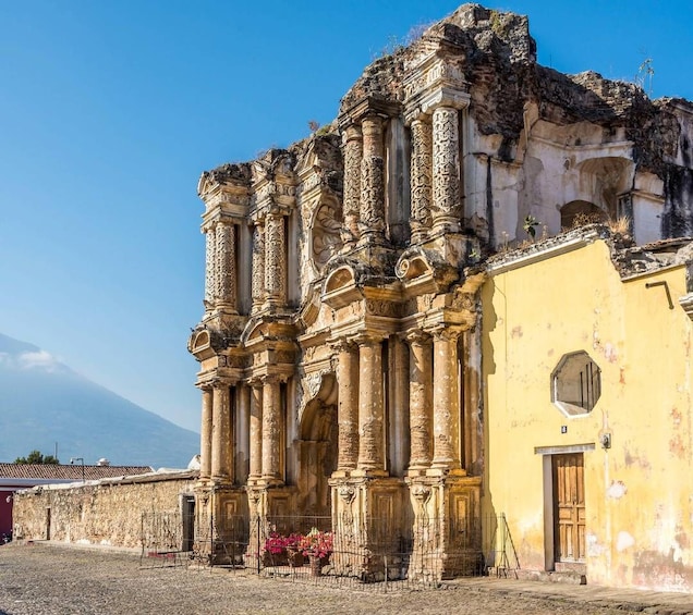 An ancient, ornate building with columns and a weathered facade. 1