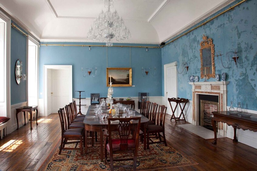 A dining room with a large wooden table set for a meal, surrounded by chairs. 5