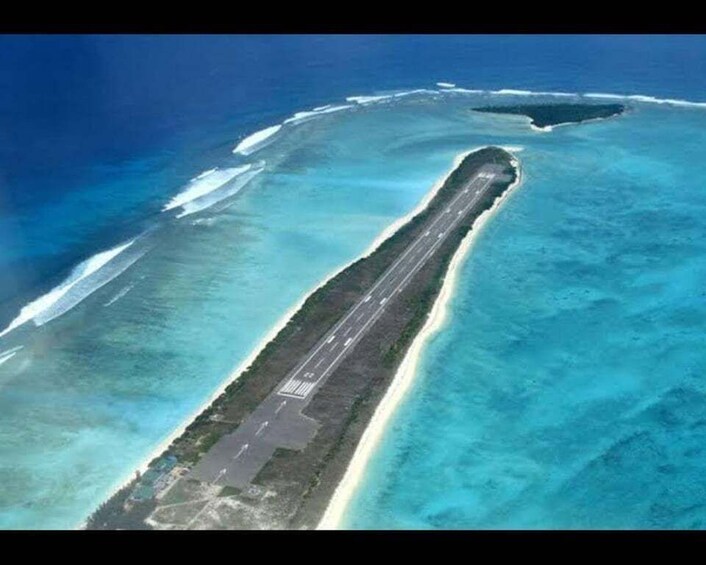 An aerial view of a long, narrow island with a runway. 3