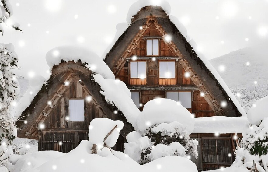 A wooden cabin with a steeply pitched roof covered in snow, surrounded by snow-covered trees. 4