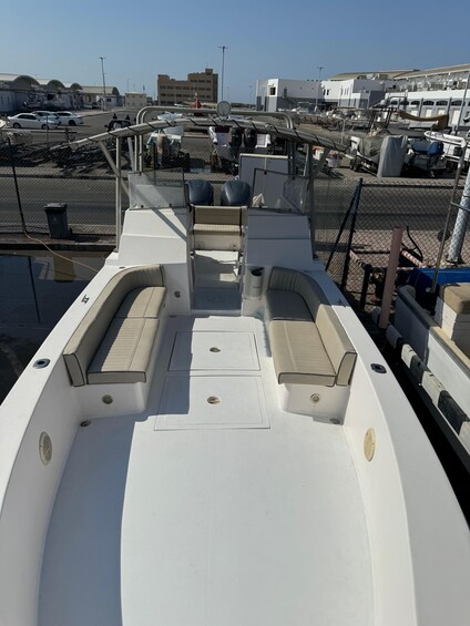 A boat deck with seating and a control panel. 3