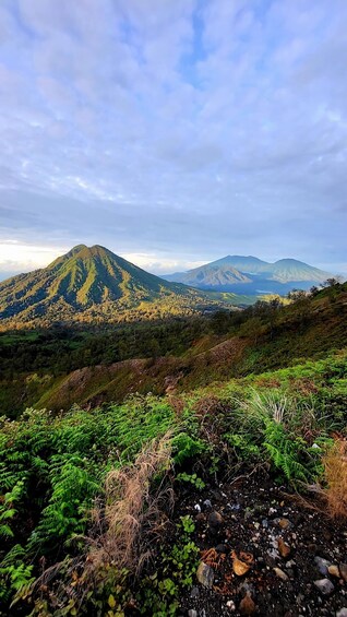 A mountainous landscape with lush greenery and a clear sky. 2
