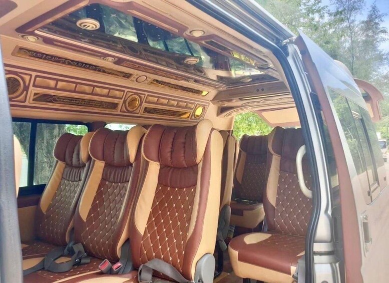 A vehicle interior with brown leather seats and a decorative ceiling. 1