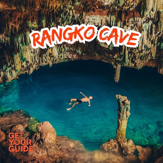 A person swimming in a clear blue cave with the text 'RANGKO CAVE' and 'GET YOUR GUIDE' visible. 1