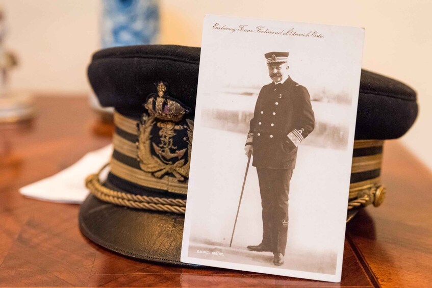 A military officer's uniform and a decorated military cap. 4