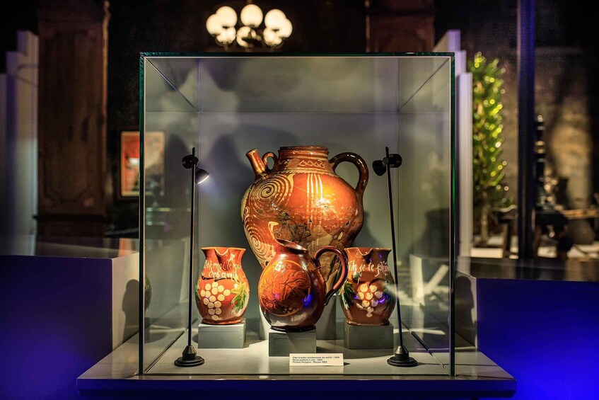 A glass display case containing ancient pottery with inscriptions. 2