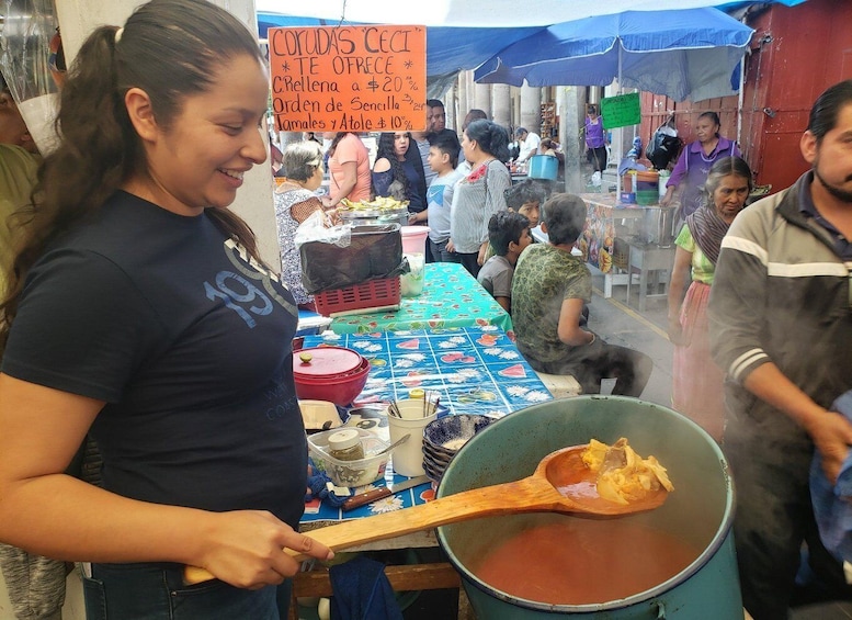 A street food vendor preparing food at a market stall. 3