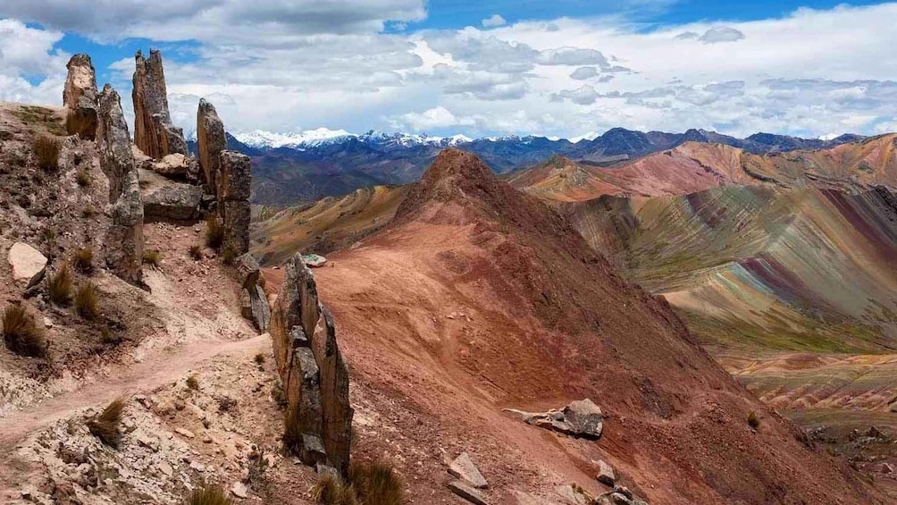 A rugged mountain landscape with prominent rock formations and a clear sky. 4