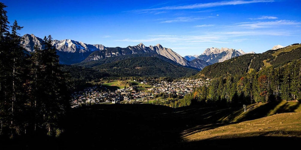 A mountainous landscape with a town nestled in the valley. 3
