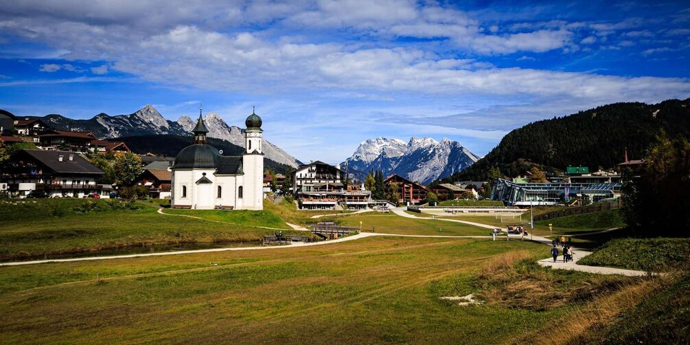 A mountainous landscape with a church, buildings, and a clear sky. 2