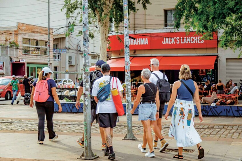 A street scene with people walking, a red awning with 'JACK'S LANCHES' text, and a building with a green door. 4