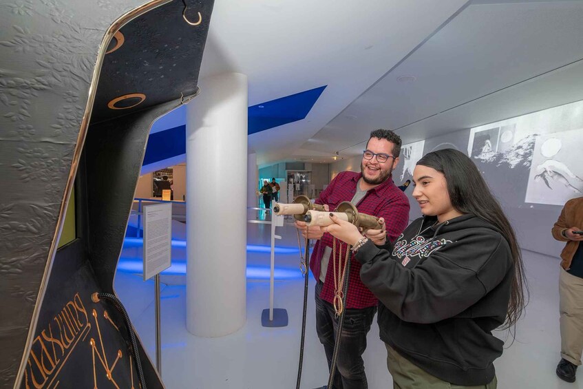 A museum exhibit with a large, curved display case and informational panels. 4