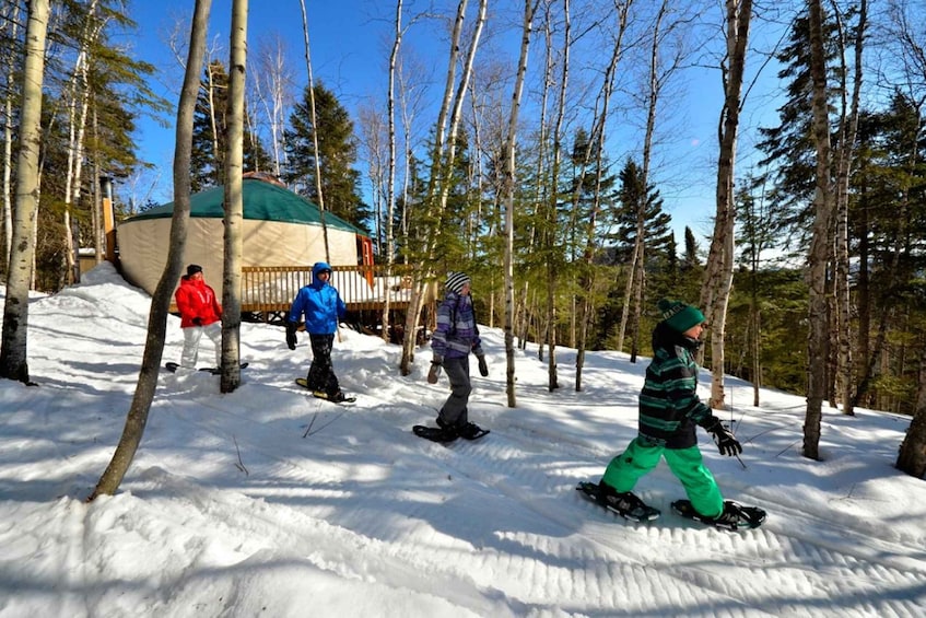 A snowy landscape with a group of people snowboarding. 3