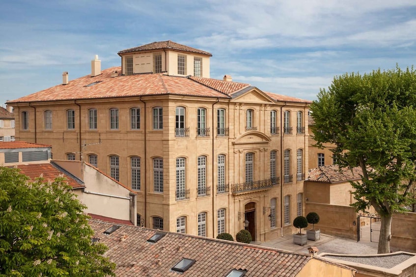 A historic building with a tiled roof and multiple windows. 2