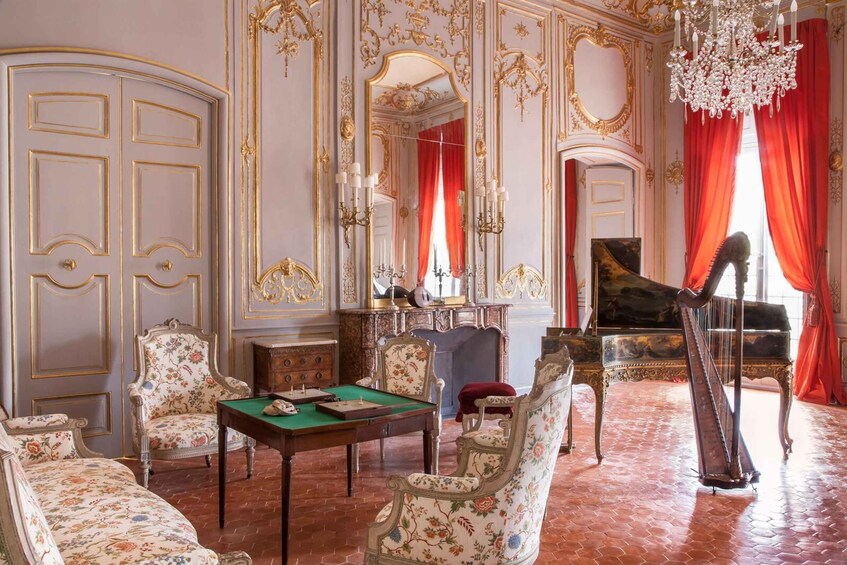 A lavishly decorated room with ornate furniture, a grand piano, a harp, and a billiards table. 3