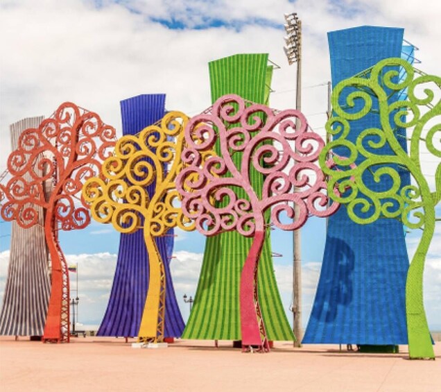 A series of colorful, abstract sculptures resembling trees with intricate designs. 2