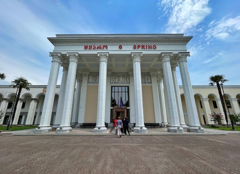 A grand building with large columns and the words 'BJS & SPRING' on the facade. 3