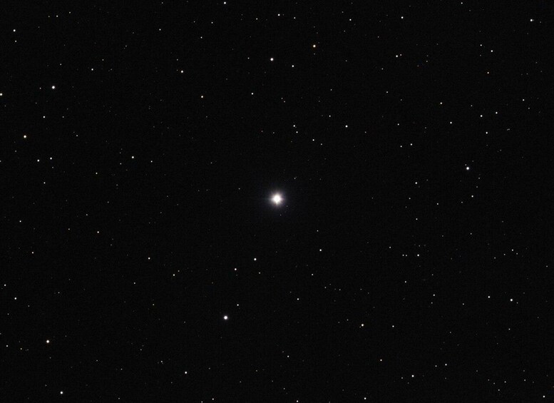 A starry night sky with a bright star and several smaller stars. 3