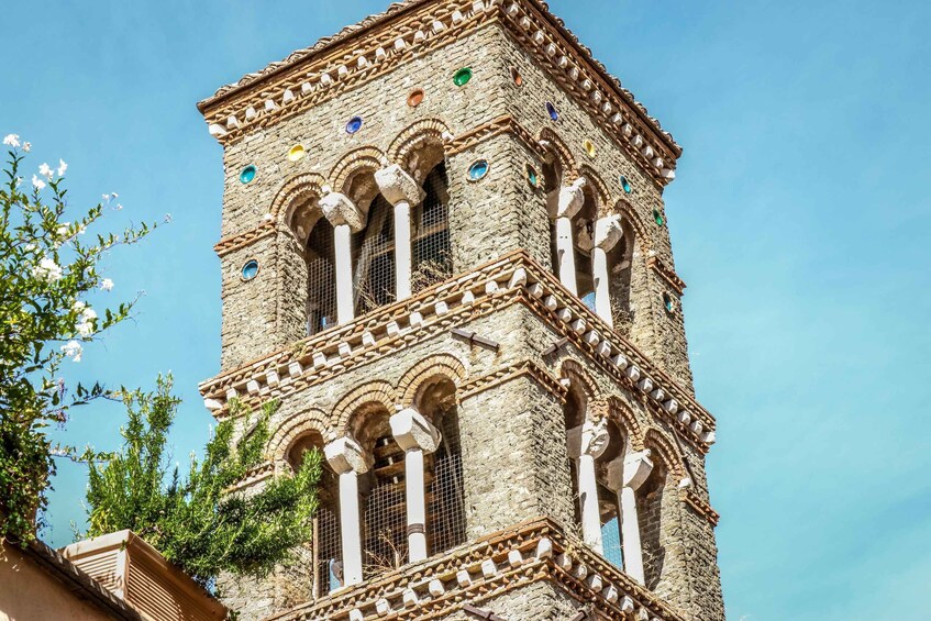 A historic tower with arched windows and decorative stonework. 4