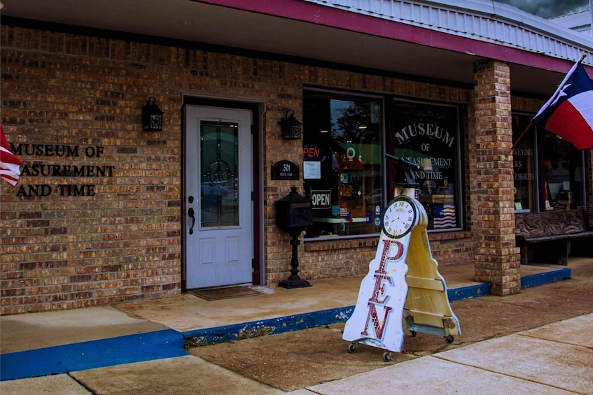 A brick building with a sign reading 'Museum of Measurement and Time.' 4