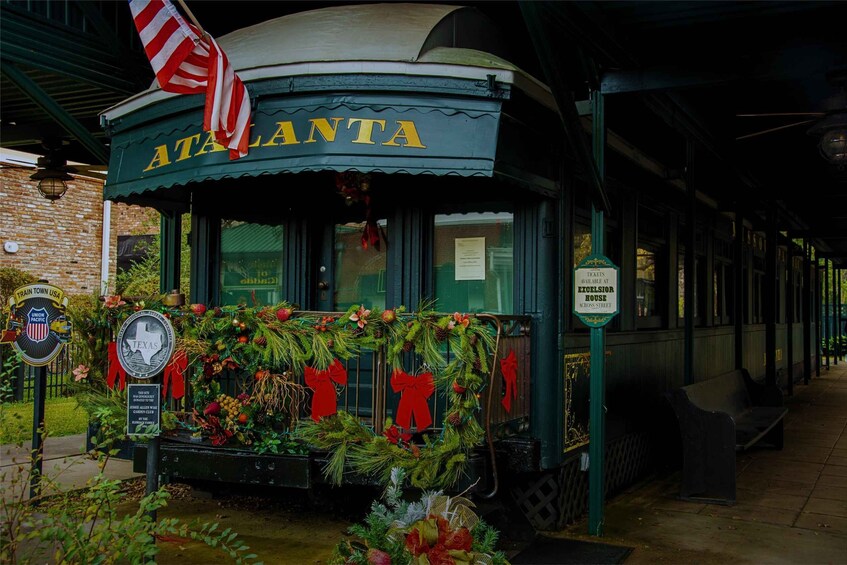 A green building with 'Atlanta' written on it, decorated with Christmas wreaths and red bows. 5