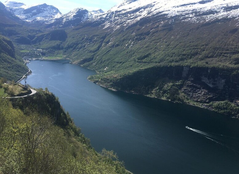 A river winding through a mountainous valley with snow-capped peaks in the background. 2