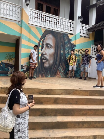 A mural of a woman's face on a building with steps leading up to it. 2