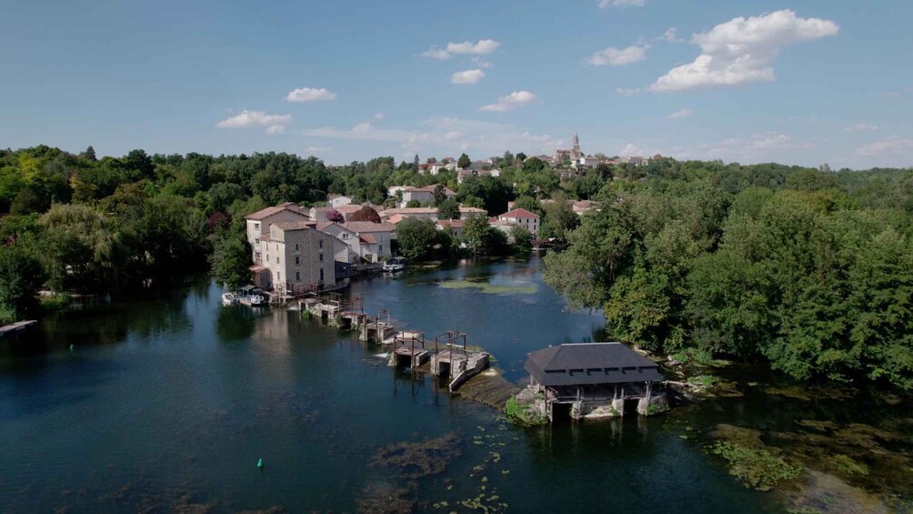 A river with buildings and a bridge. 3