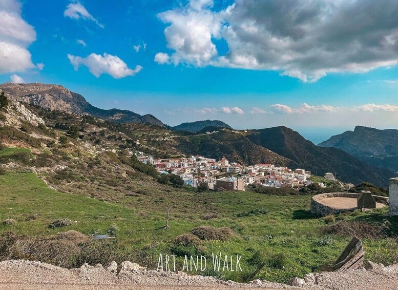 A coastal town nestled in a valley with mountains in the background. 3
