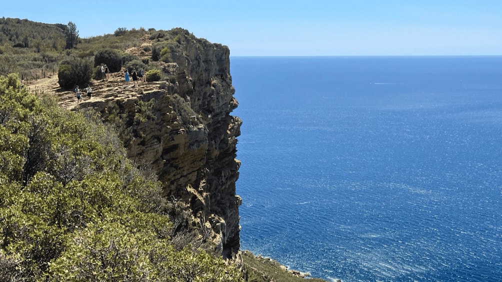 A coastal cliff with ruins and a clear view of the sea. 5