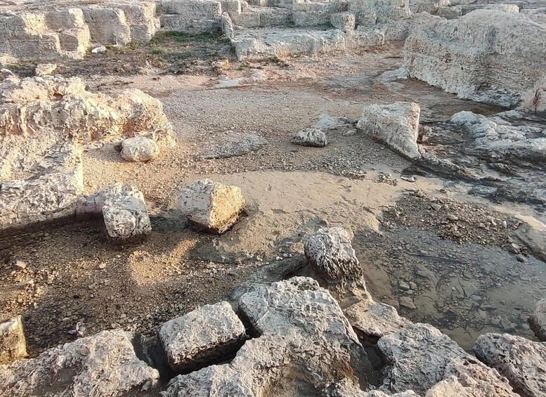 Ancient ruins with large stone blocks and scattered rubble. 5