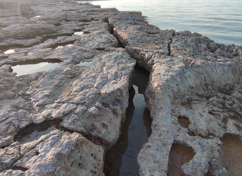 A rocky shoreline with a narrow water channel. 4