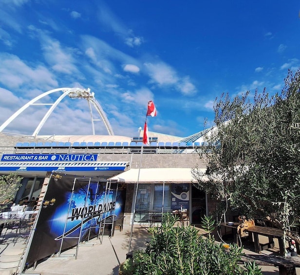 A nautical-themed restaurant and bar named 'Nautica' with a large sign and a flag. 1