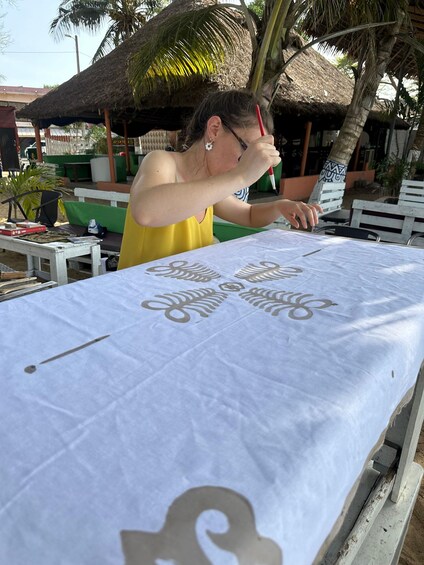 A person drawing on a table with a pen. 5