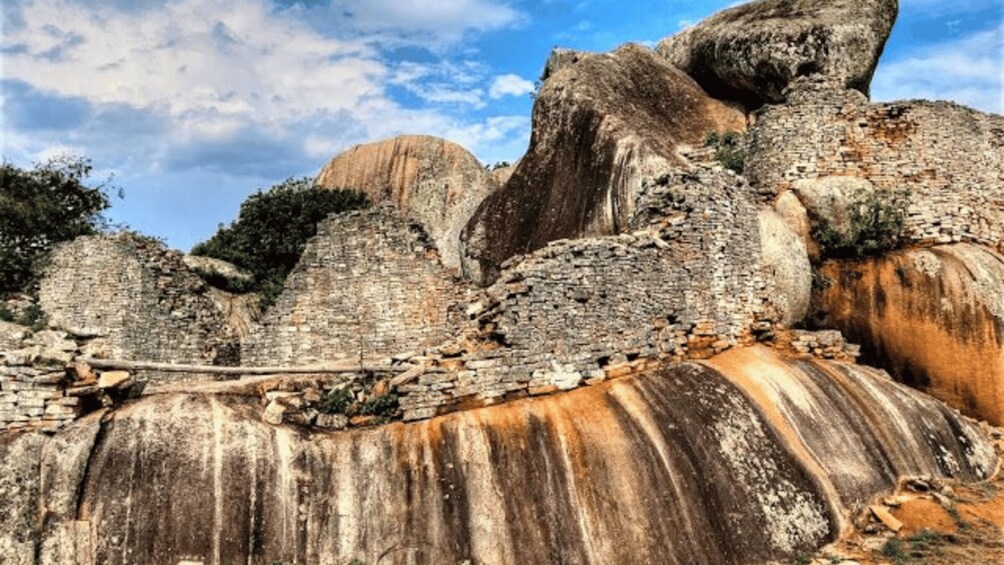 Ancient ruins with large stone structures and a clear sky. 2