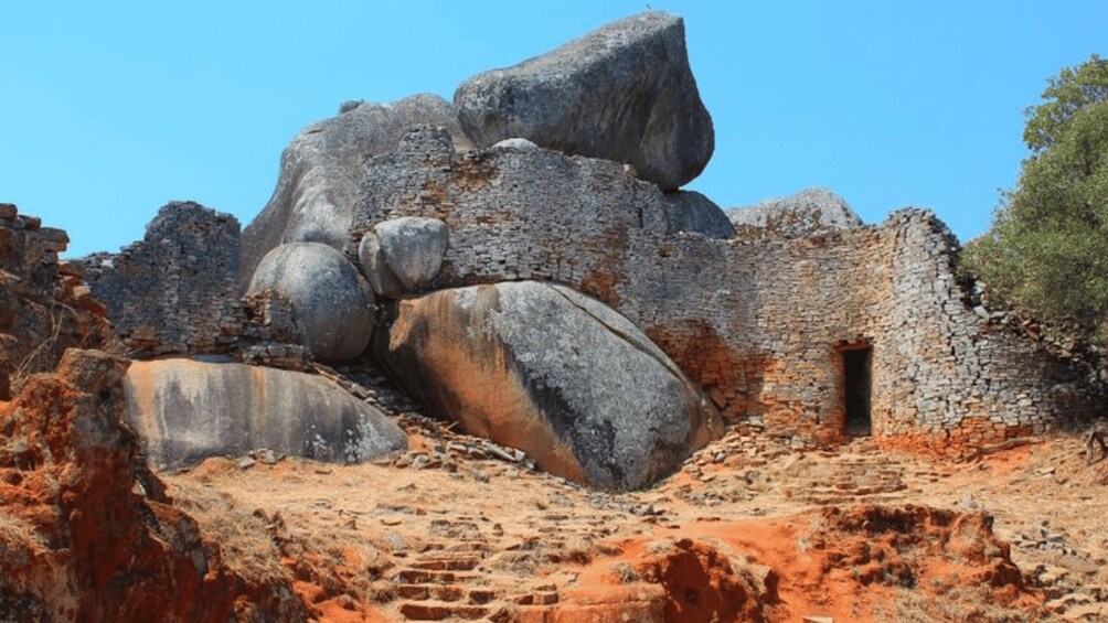 Ancient ruins with large boulders and a small doorway. 3