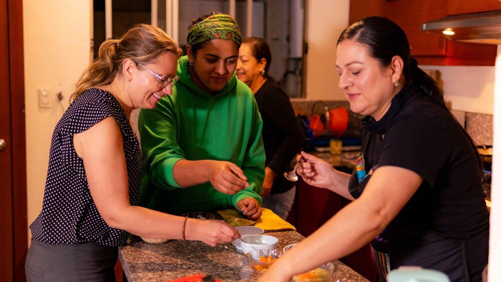 Three people cooking together in a kitchen. 4