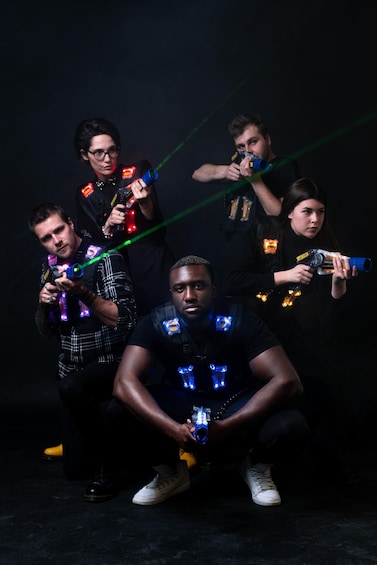 A group of people with glow sticks and toy guns. 5