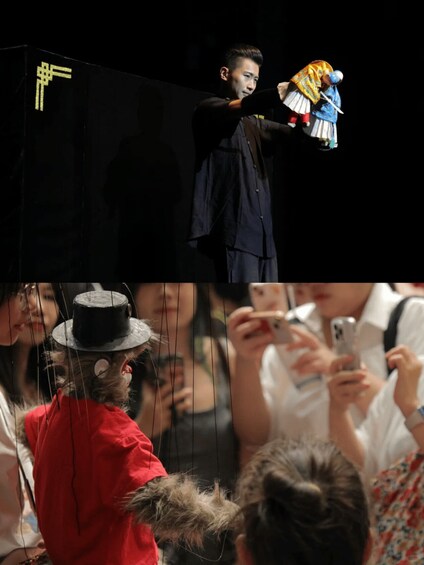 A person in a dark shirt performing with a puppet. 3