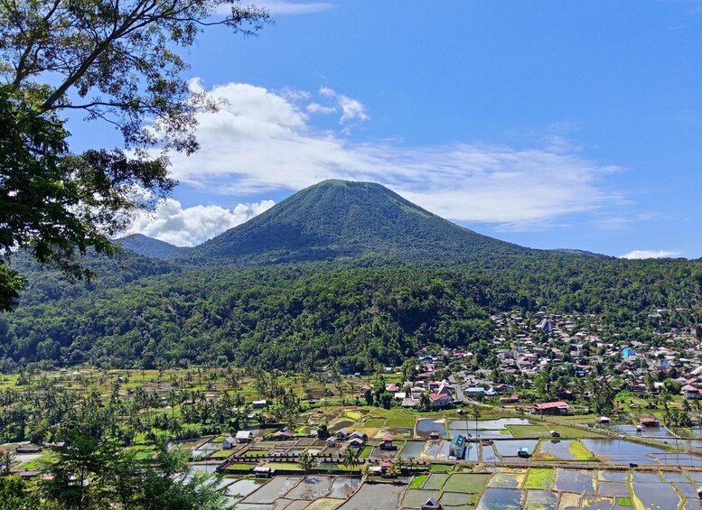 A mountain with a village in the foreground and a clear sky. 2