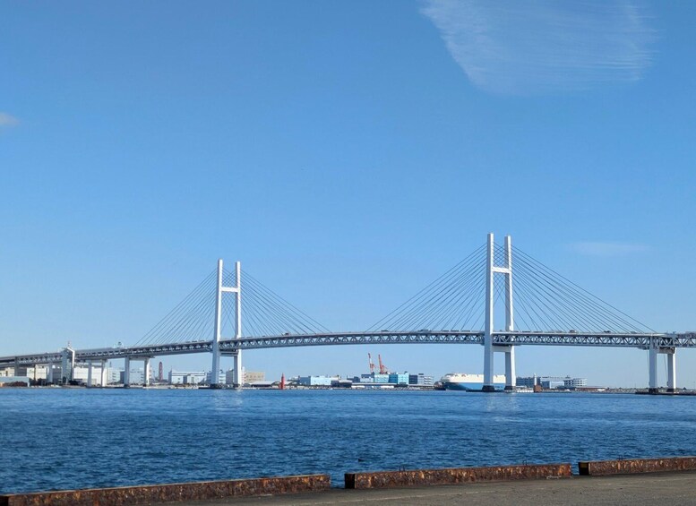 A large suspension bridge with two tall towers and cables spanning across a body of water. 3