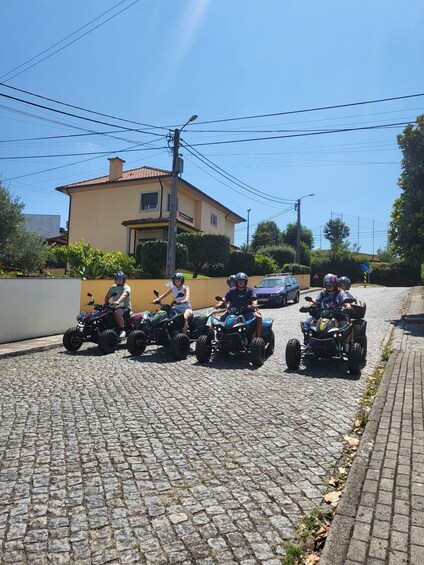 A group of people on ATVs on a cobblestone street. 3