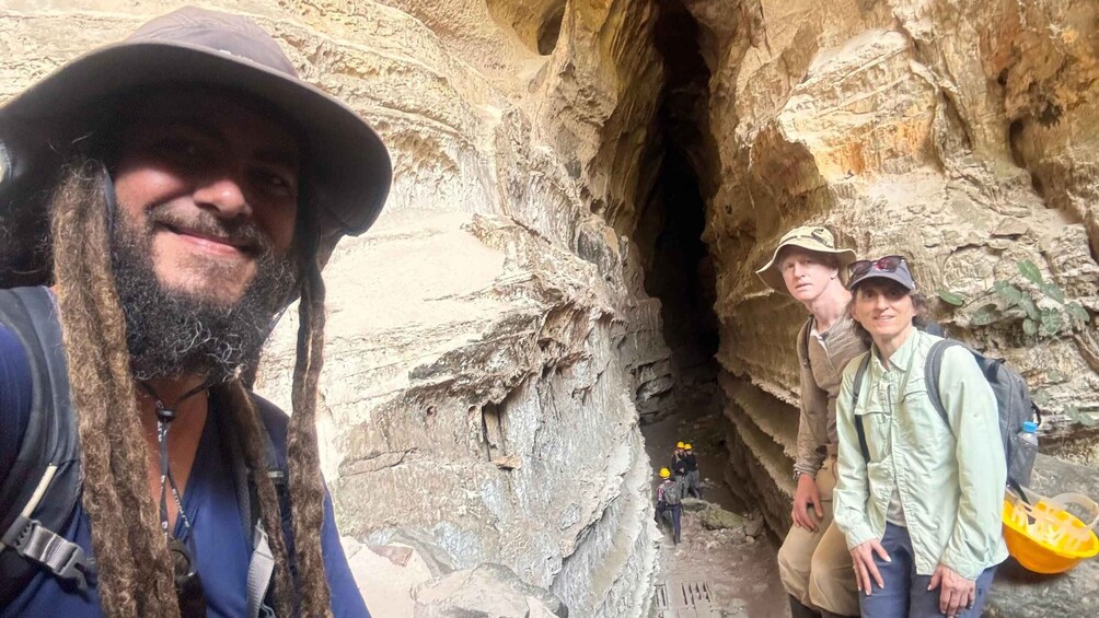 A group of people in a rocky cave environment. 1
