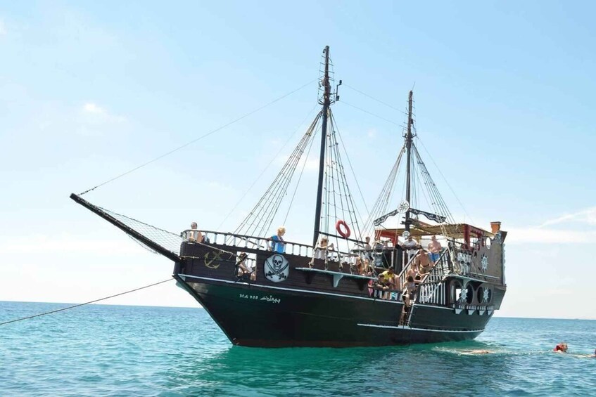 A large sailing ship with multiple masts and rigging, sailing on a calm sea. 1