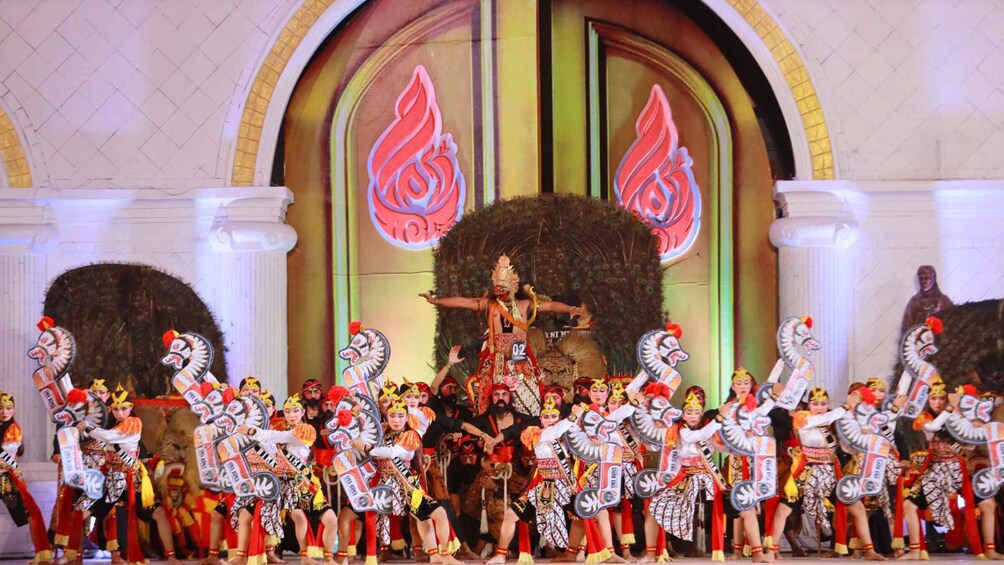 A traditional dance performance with performers in colorful costumes and peacock feather headdresses. 5