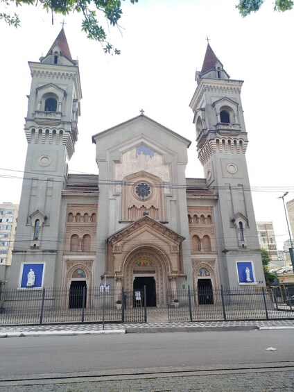 A large church with two towers, intricate facade, and a clock. 4
