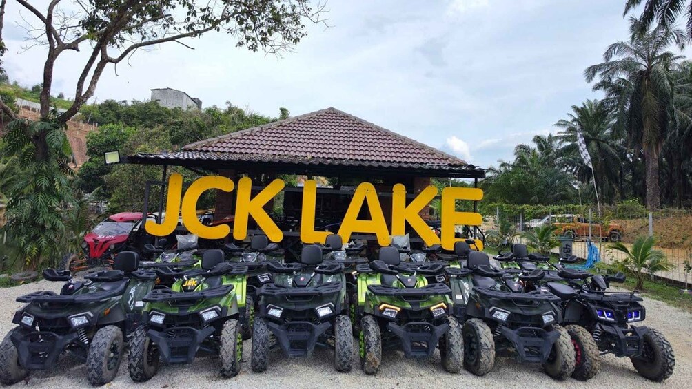 A collection of ATVs parked in front of a building with a sign that reads 'JCK LAKE'. 1